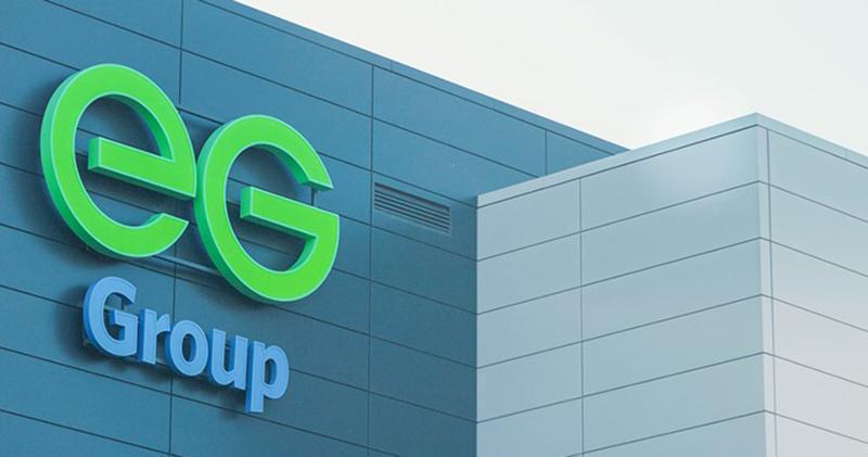 Exterior view of an EG Group building featuring large green and blue company signage mounted on a modern gray facade.