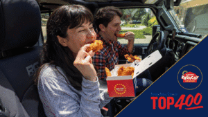 Two guests enjoy Krispy Krunchy Chicken fried chicken inside a Jeep, celebrating the brand’s first Franchise Times Top 400 ranking at No. 95.