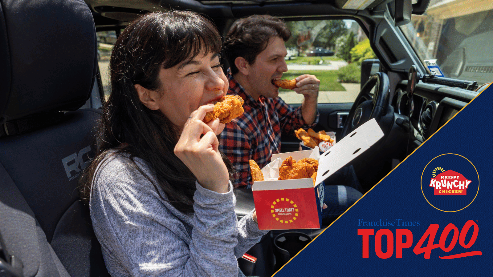 Two guests enjoy Krispy Krunchy Chicken fried chicken inside a Jeep, celebrating the brand’s first Franchise Times Top 400 ranking at No. 95.