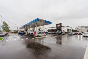 Exterior of a US Market convenience store and Space Age gas station on a rainy day